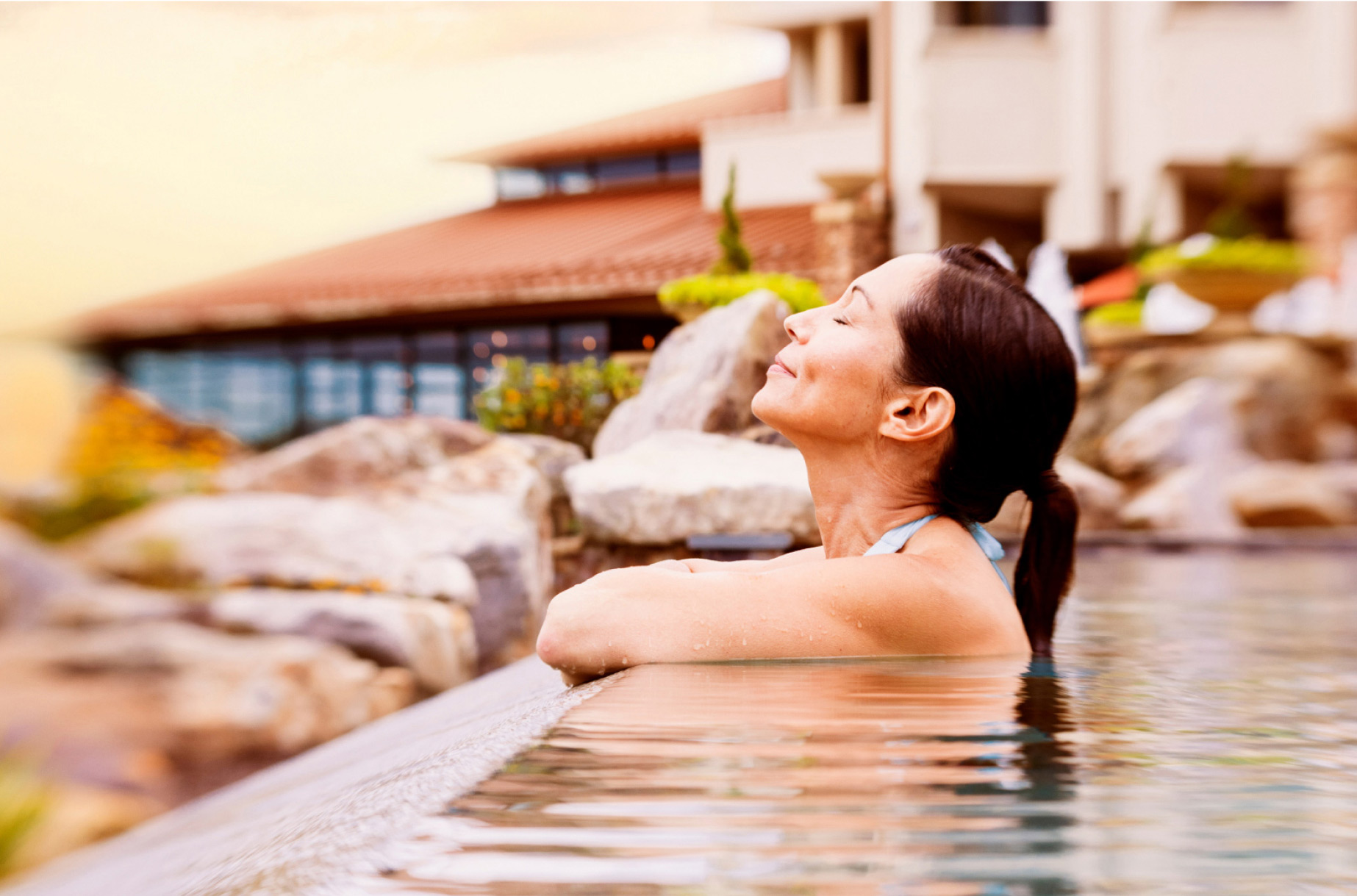 woman on the edge of a pool looking up